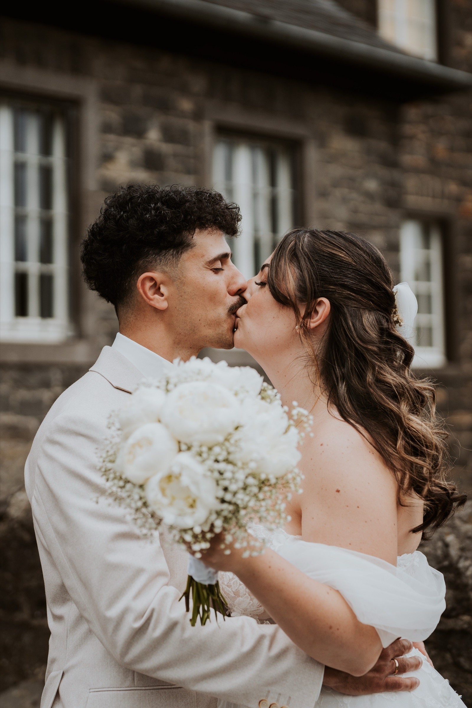 A wedding couple sharing a kiss.