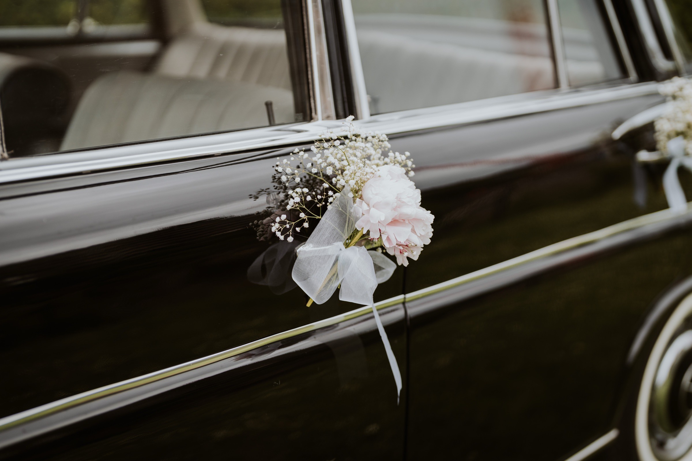 Flowers decorating the wedding car.