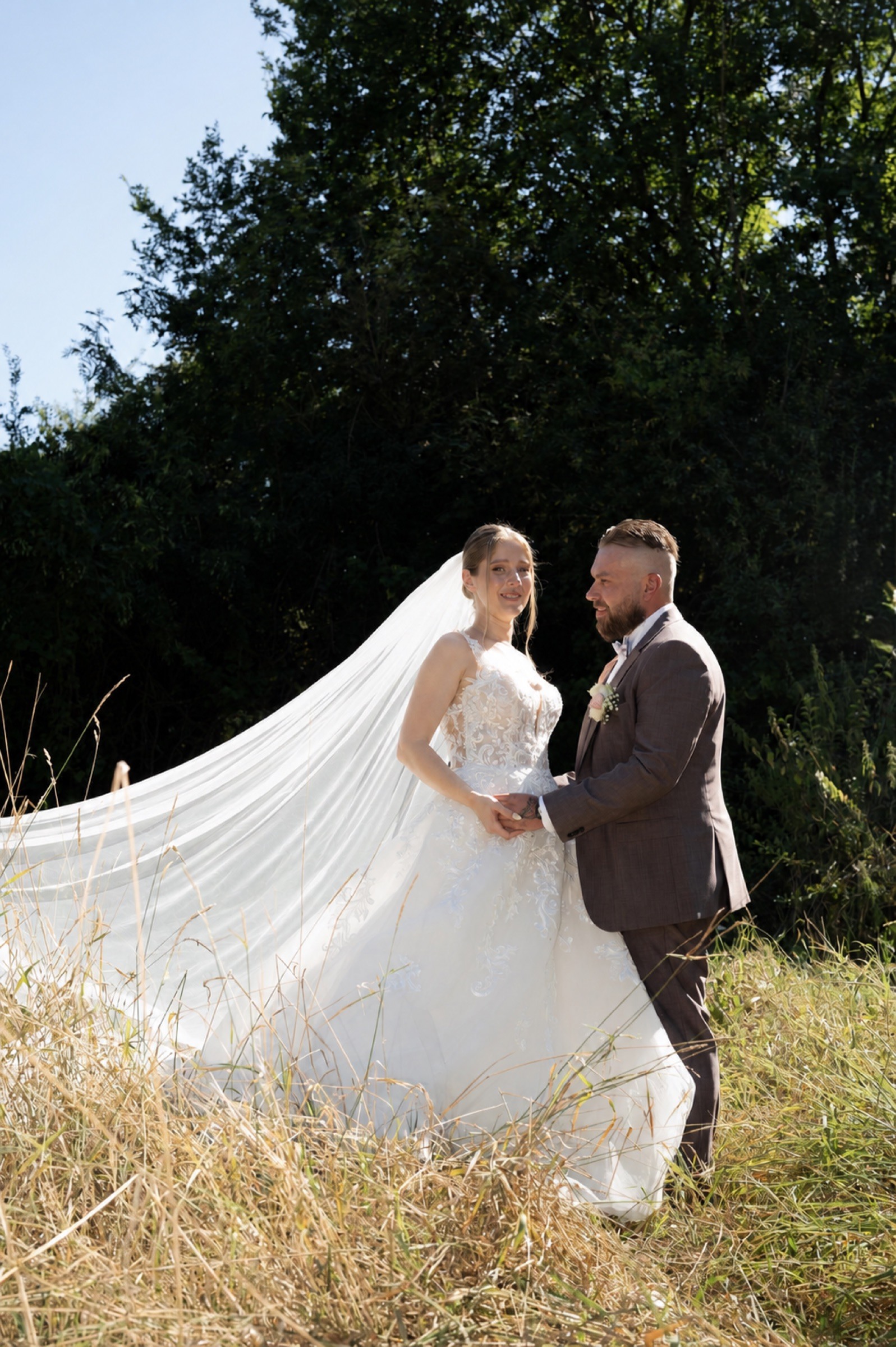 A wedding couple in a summer meadow.